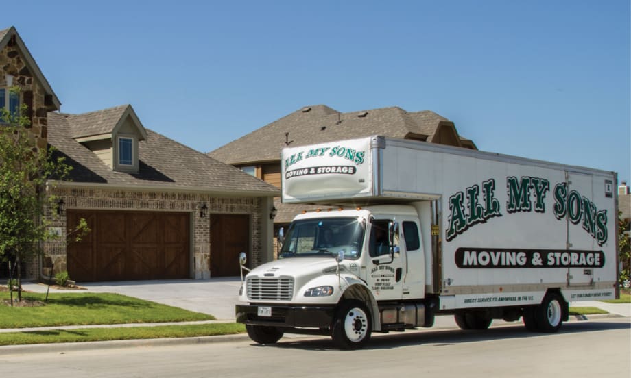 An All My Sons Moving & Storage truck outside a residential home in a neighborhood.