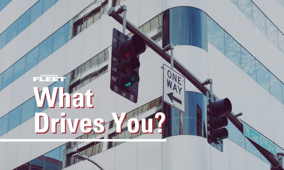 Image of a building and stop lights with text reading, "What Drives You?"