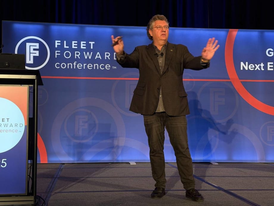Speaker Bill Sims on the FFC stage with both hands up, emphasizing a point during his safety keynote address.