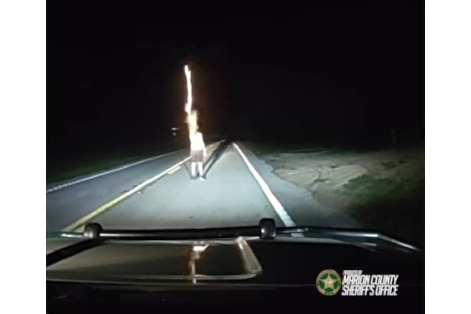 Nighttime dashboard view of police vehicle dashcam with road ahead