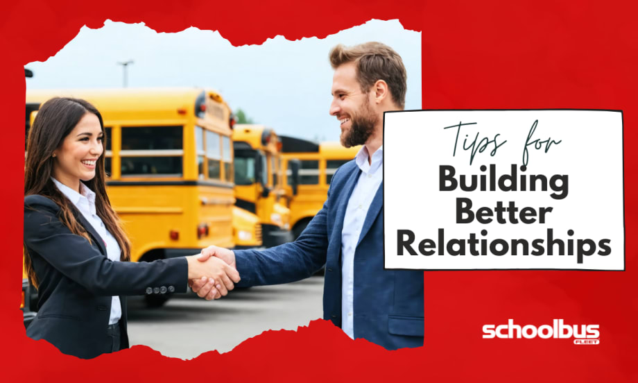 An image of a woman and a man, both dressed in professional attire, shaking hands in a school bus dealership lot surrounded by various buses.