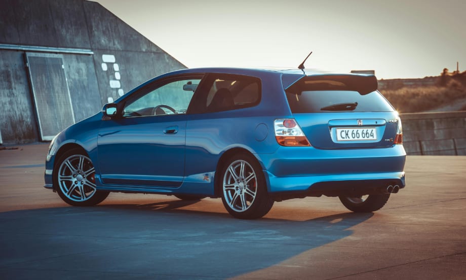 blue Honda hatchback outside