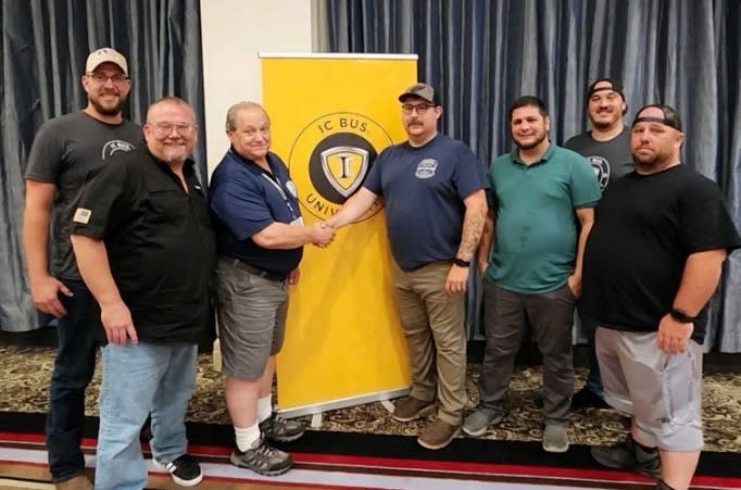 a group of men stand in a conference room