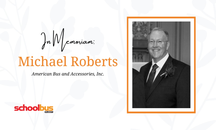 a black and white photo of michael roberts against a white flowery background with text that says "In memoriam Michael Roberts"