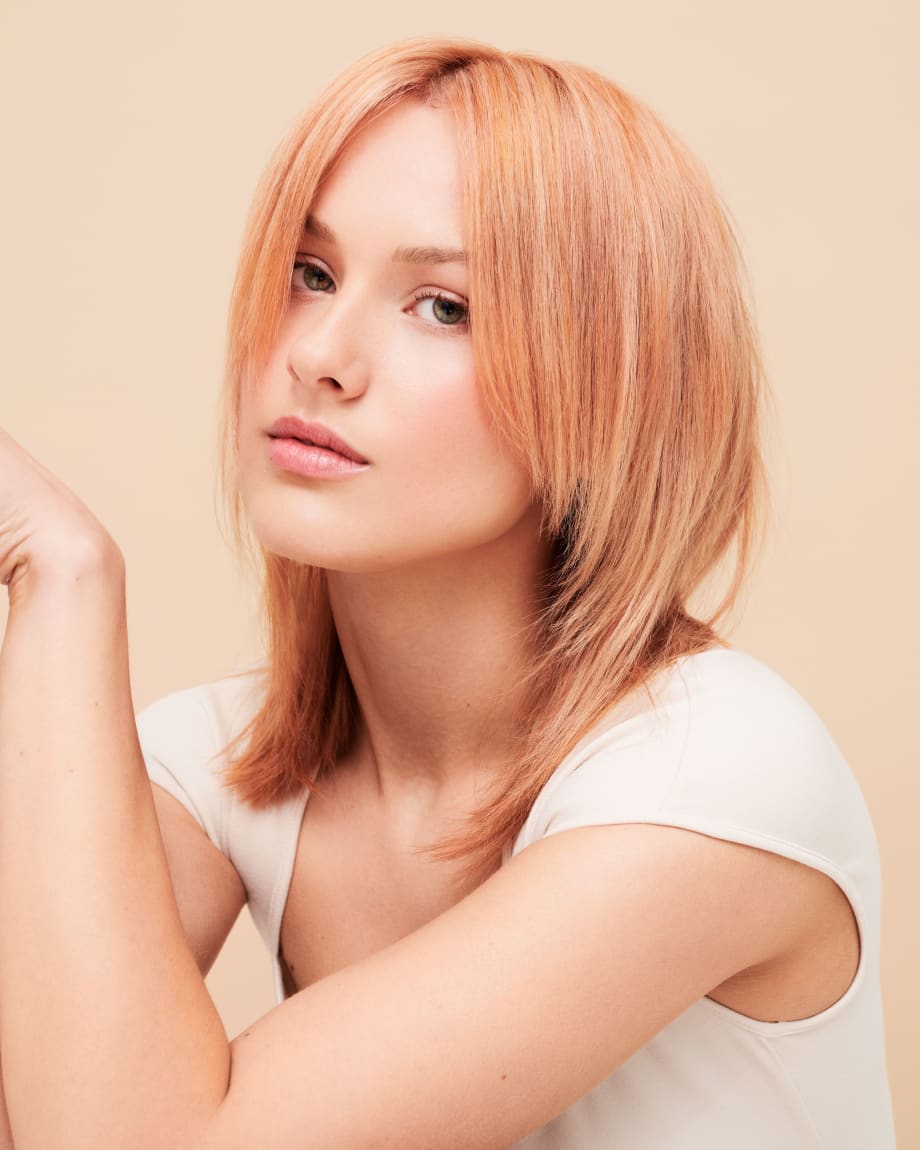 A woman with peach-colored hair.