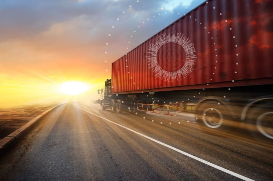 Illustration of an intermodal container on the road going into a sunset or sunrise with internet of things graphics.