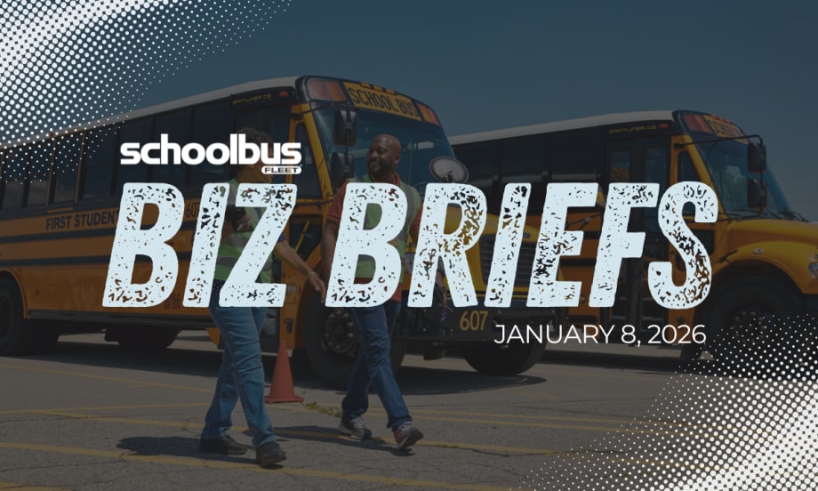 Image of two people in high visibility vest walking in front of parked school buses with text reading "Biz Briefs."