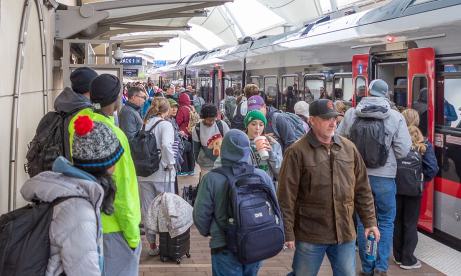 Airport goers wait to board Trinity Metro's TEXRail at DFW Airport.