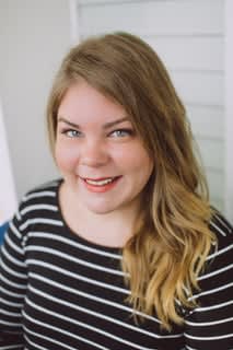 Former salon owner Jena Berenberg smiles into the camera.