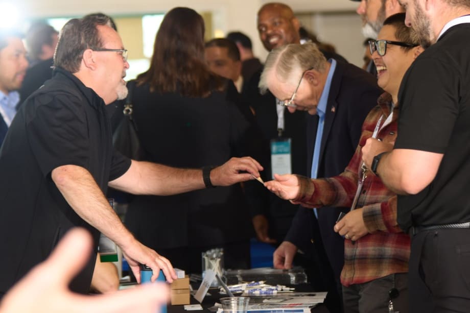 A group of people network at a Fleet Forward: the Tour event.