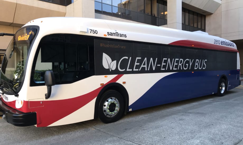 A red, white, and blue SamTrans clean-energy bus.