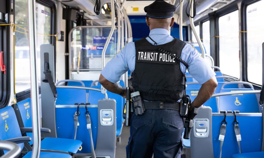 Transit police walks inside an empty SEPTA bus.