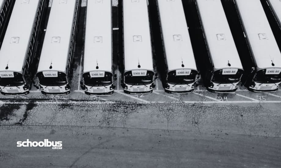 Black and white aerial view of a bus lot.