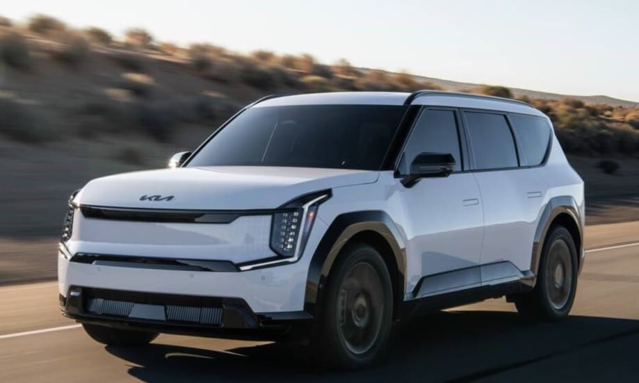 A 2026 Kia EV9 driving on the road.