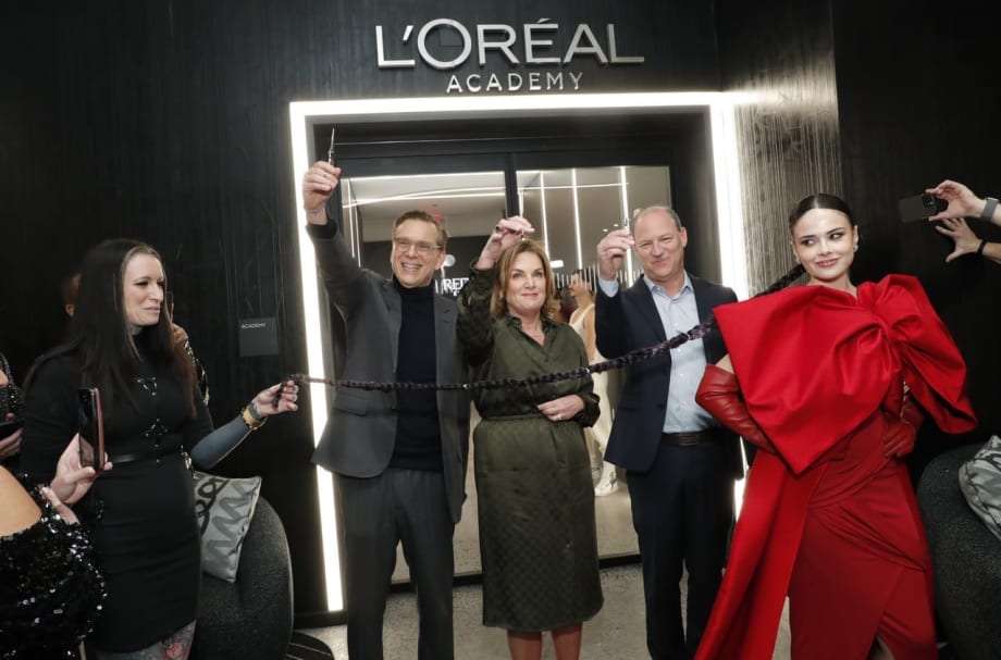 A ribbon cutting in front of the L'Oreal Academy.