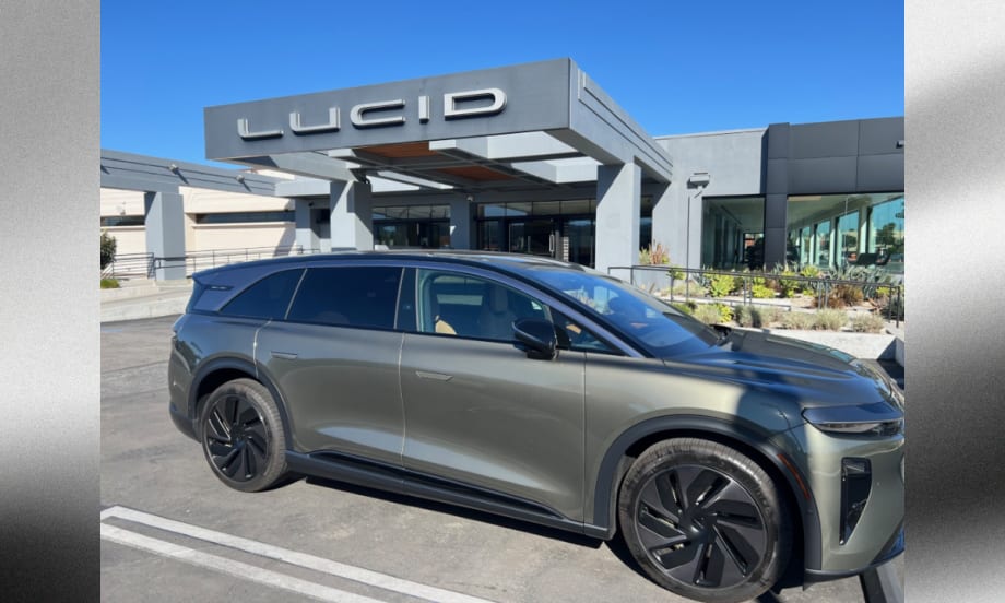 Lucid Gravity electric SUV parked outside a Lucid dealership, highlighting the company’s expanding EV lineup and plans for a new midsize platform and future mobility technologies.