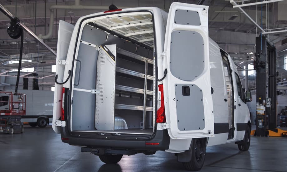 A Mercedes-Benz van with the back doors open.