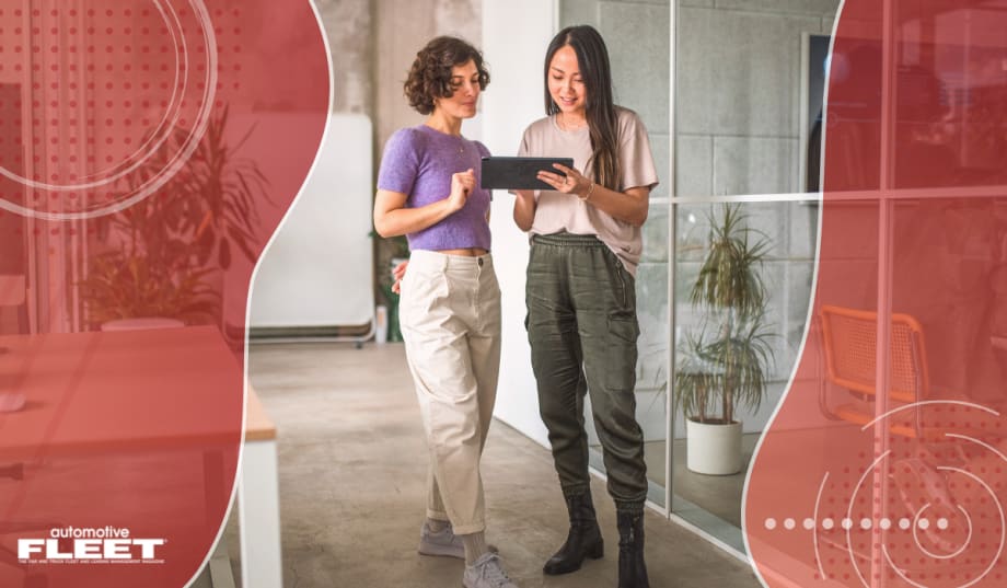 Red graphic of organic shapes with a picture of two women collaborating at work.