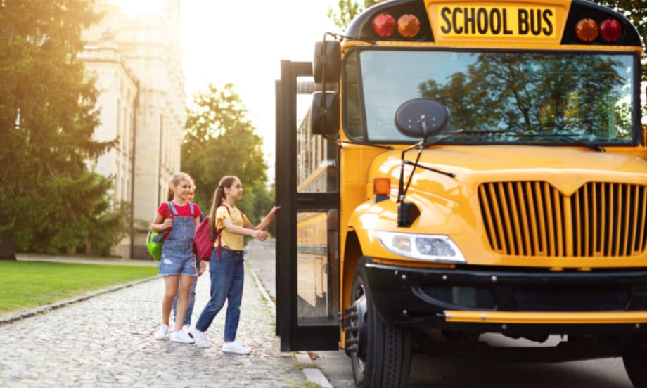 Children boarding a school bus.