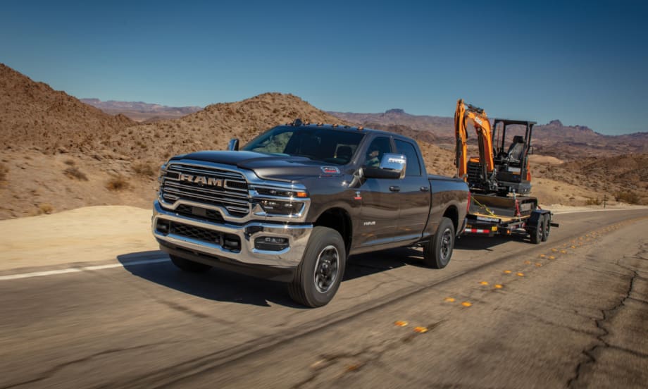 A Ram truck hauling construction equipment.