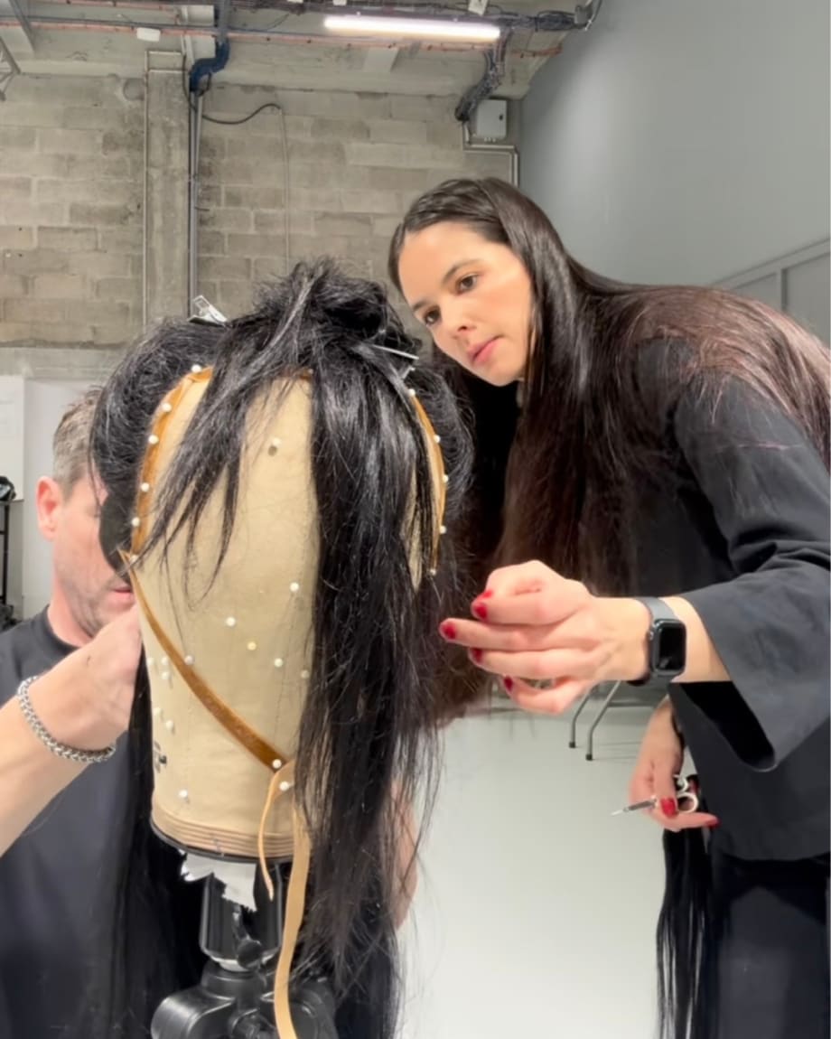 Michelle Bowden works on a hair piece on a mannequin