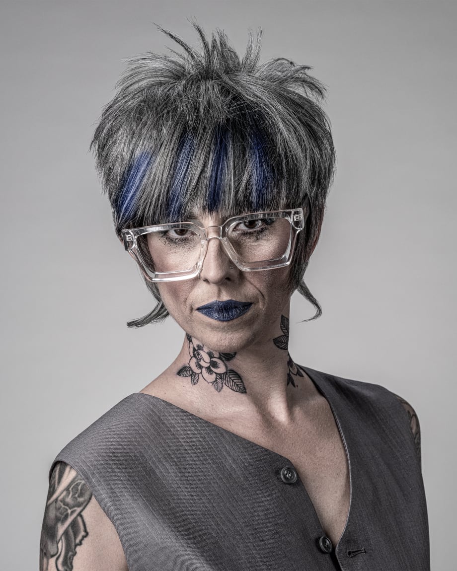 Older woman with big clear glasses and short hair