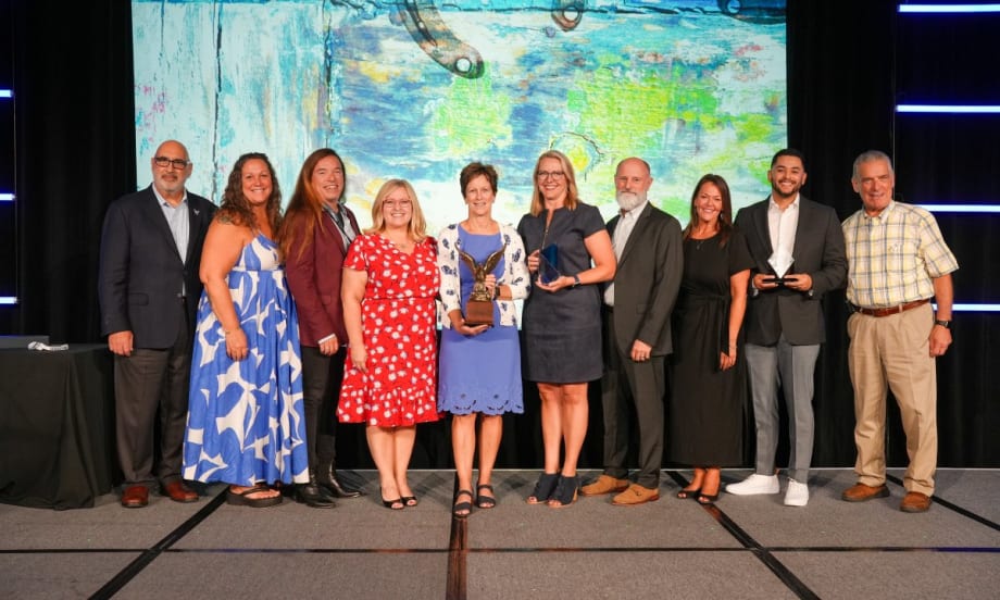 A group of past and present Fleet Managers of the Year and other award recipients pose on stage at the AFLA corporate fleet conference in San Antonio with the newest award winners.