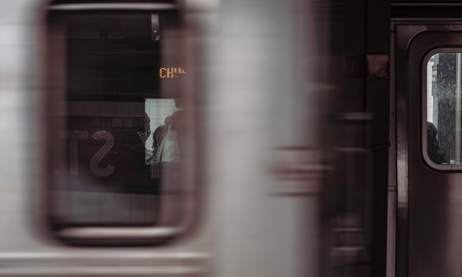 A blurry image of a subway vehicle passing by.
