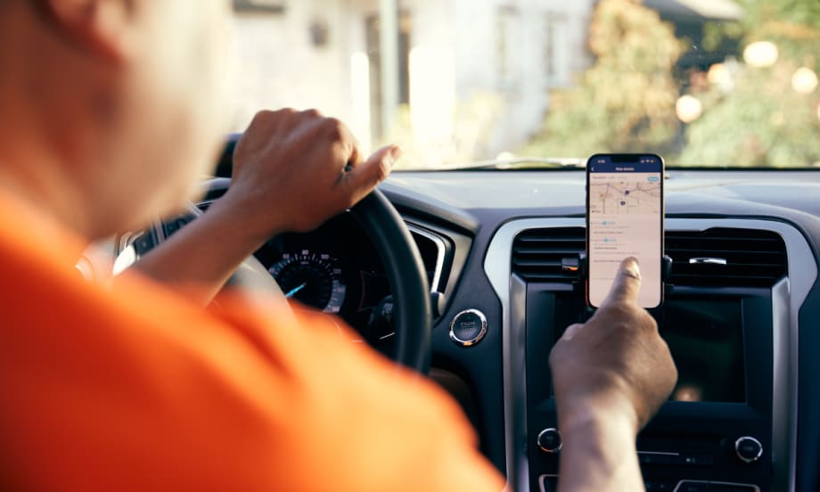 A HopSkipDrive CareDriver uses a mobile navigation app.
