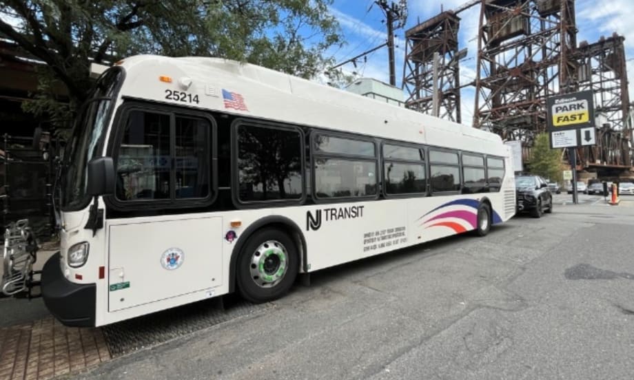 A white NJ Transit bus on a street.