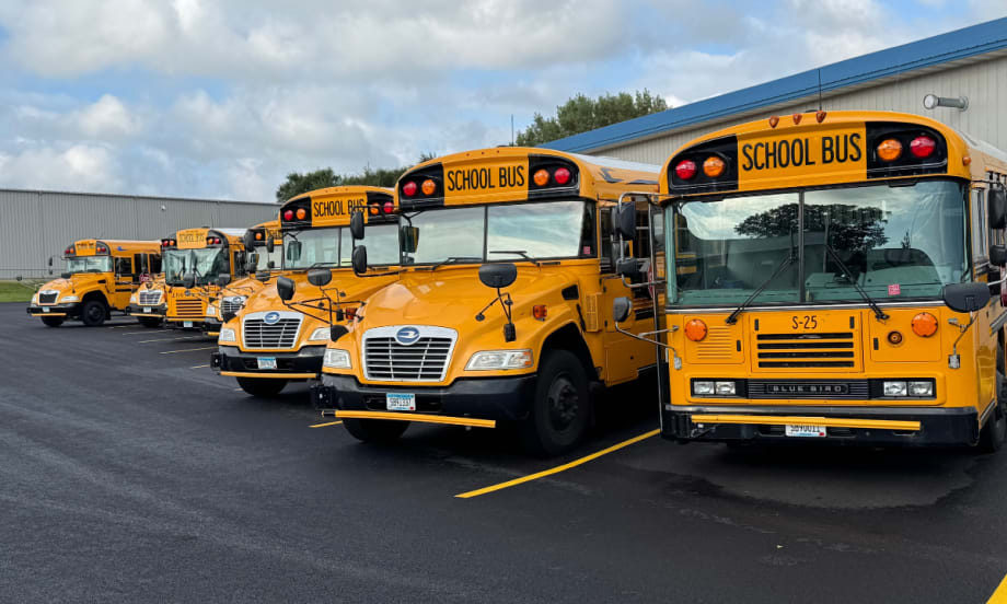 Spanier Bus Service buses lined up in parking spots.