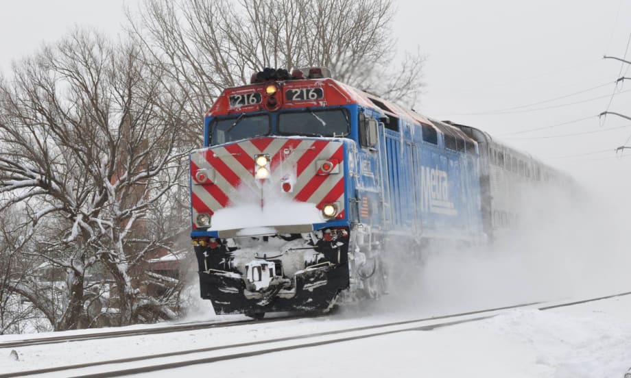 A Metra train operating in the snow.
