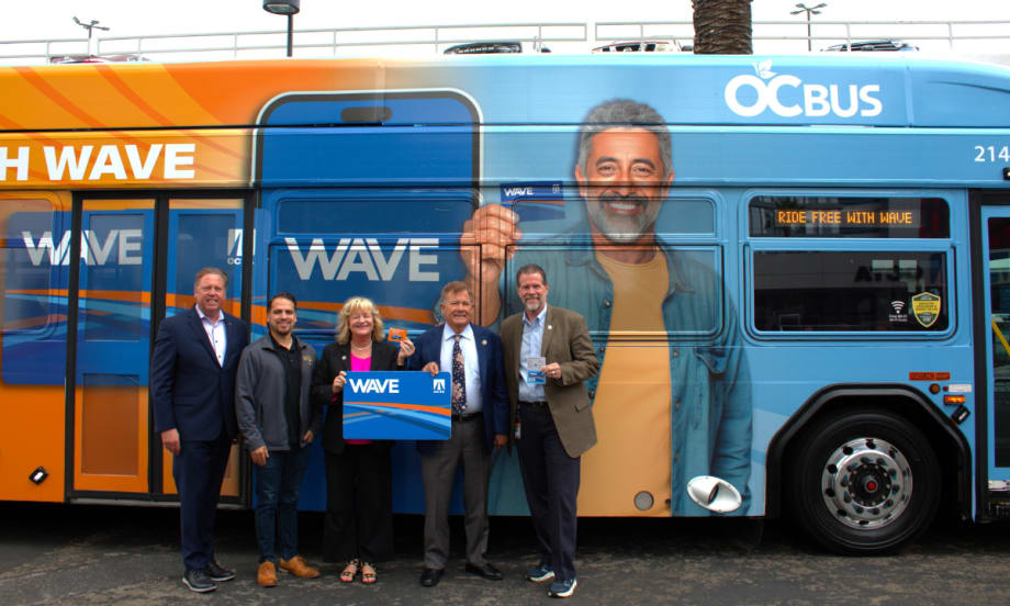 OCTA Board Members and staff pose in front of an OCTA bus.