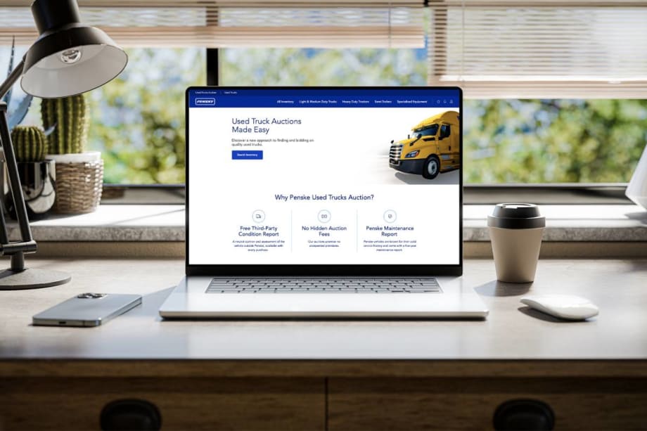 Computer with screen showing a used truck auction bidding website.