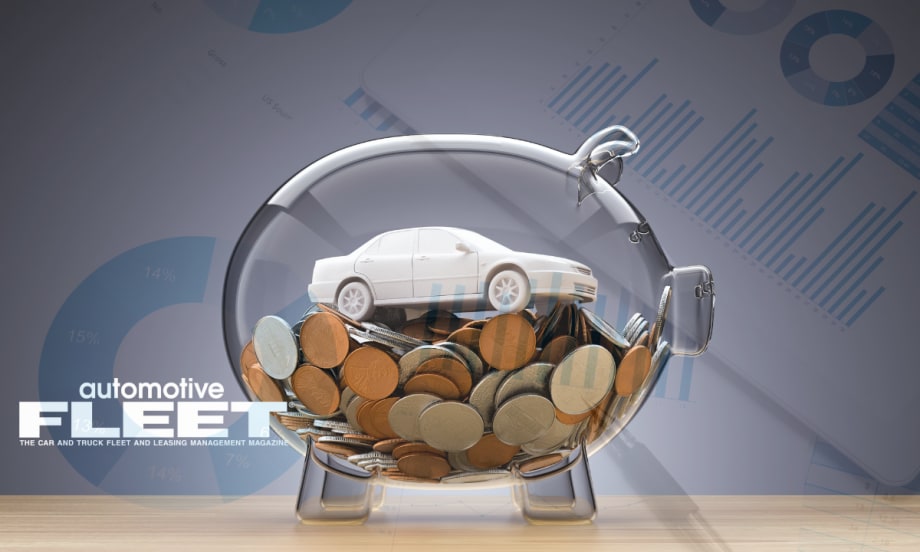 Photo of toy car in glass piggy bank.