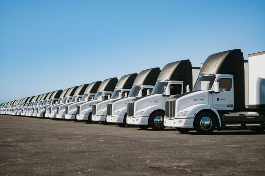 A row of new Peterbilt Model 579EV electric trucks.