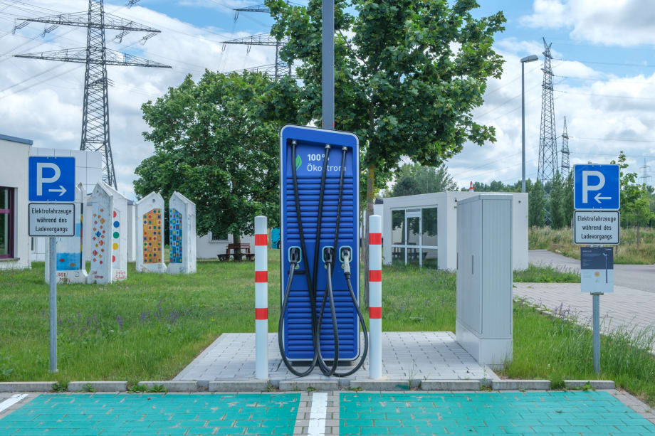 public electric vehicle charging station with one charger and two parking spots
