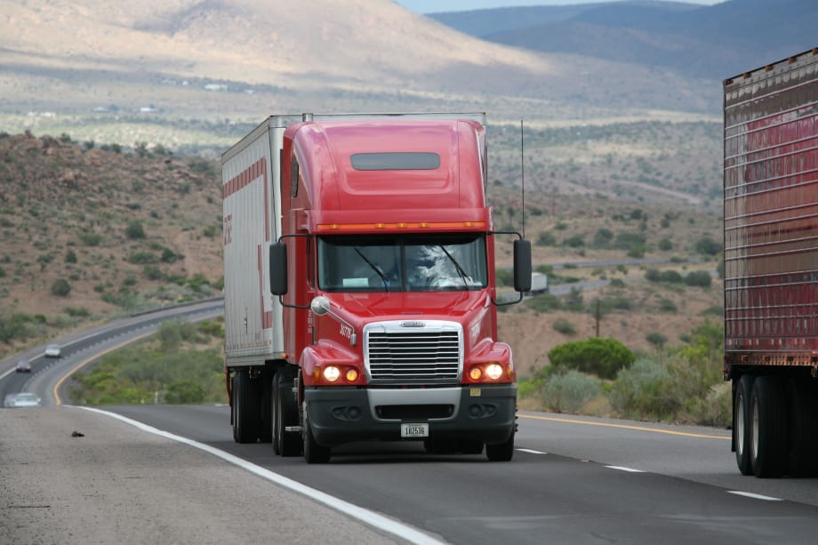photo of tractor-trailers moving on a rural U.S. highway