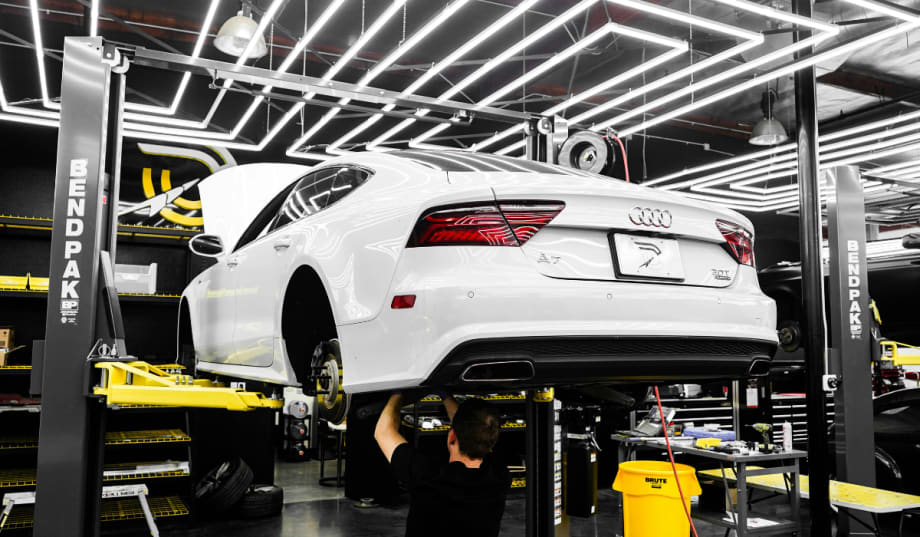 white Audi car in a service bay