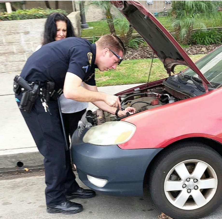 Photo: California Officer Helps Woman Install New Car Battery After Theft
