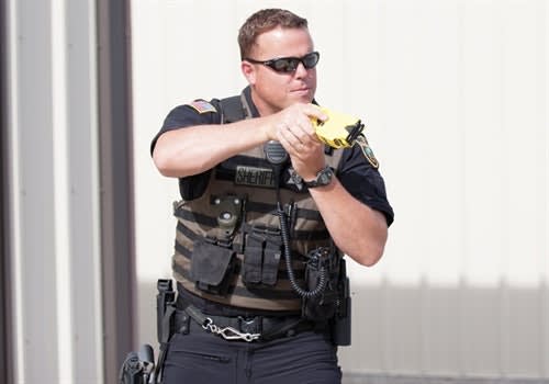 It's best to draw the TASER with your non-dominant hand, even if you transition to your strong hand after the draw. (Photo: Carla Blazek, Tumbled Bones Photography)