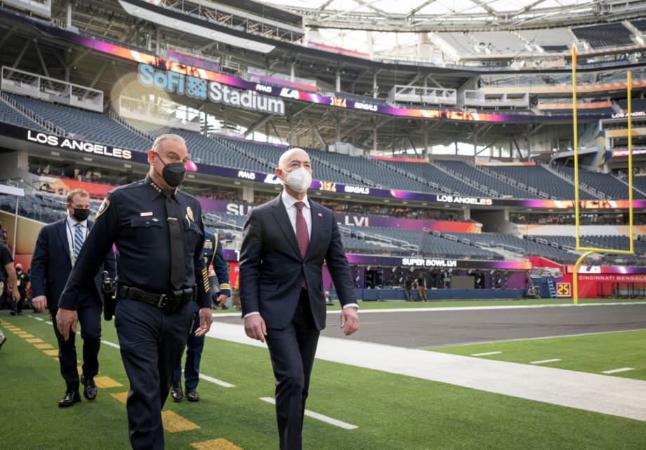 Alejandro Mayorkas, secretary of the Department of Homeland Security, walks along the field at SoFi Stadium with Inglewood Police Chief Mark Fronterotta while working with state and local law enforcement and the National Football League to review DHS operations prior to Super Bowl LVI.[|CREDIT|]Photo: U.S. Department of Homeland Security/Benjamin Applebaum