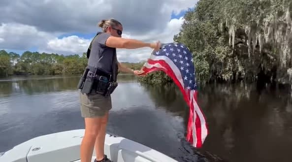 FL Deputy Pulls American Flag from Hurricane Swollen River