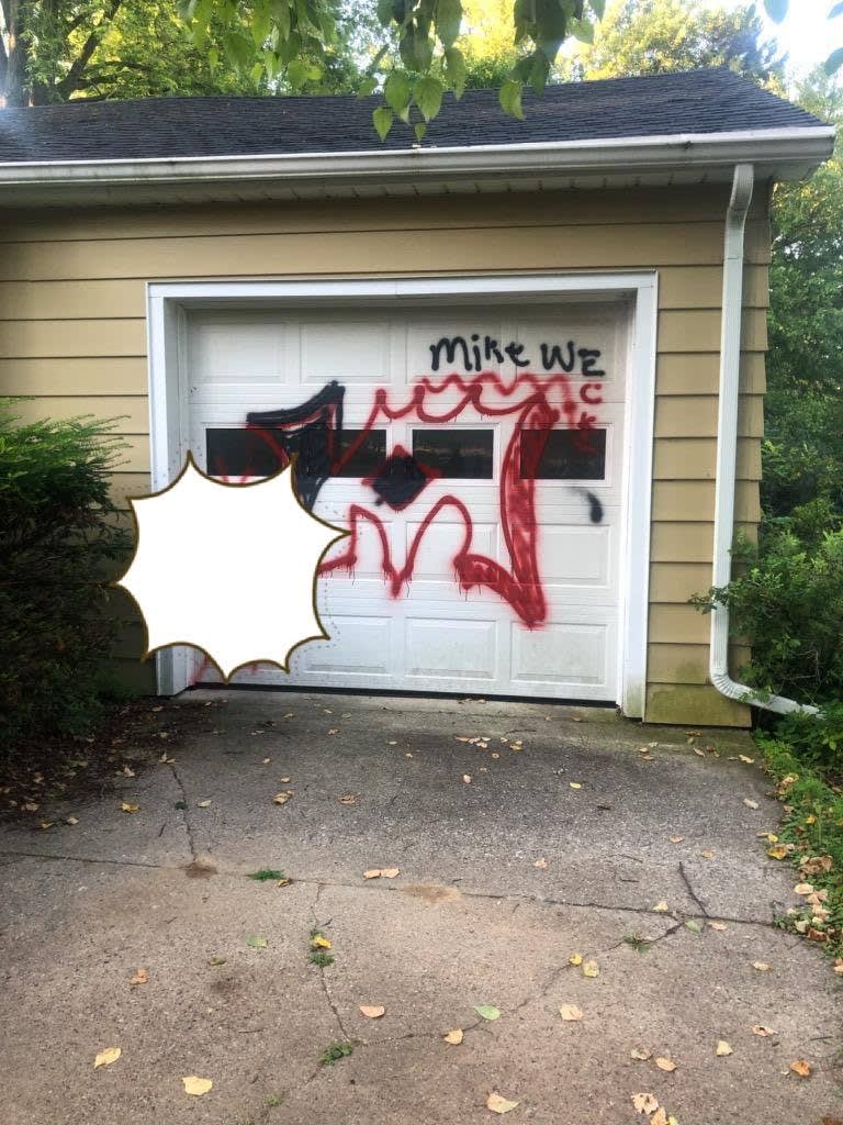 Wisconsin Officer Paints Over Graffiti on Elderly Man's Garage Door