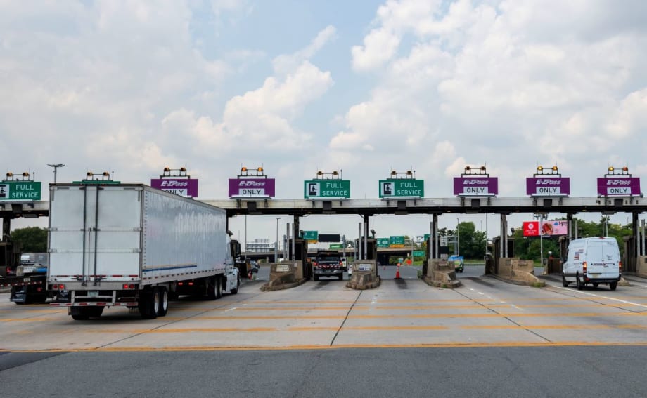 Trucks at a highway tolling station.