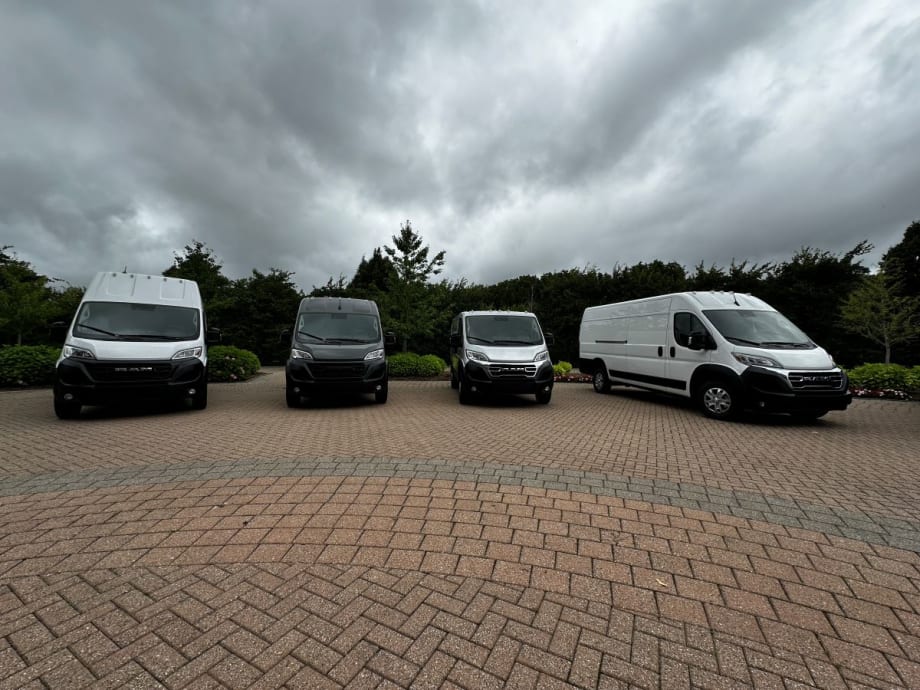 Lineup of commercial vans in parking lot.
