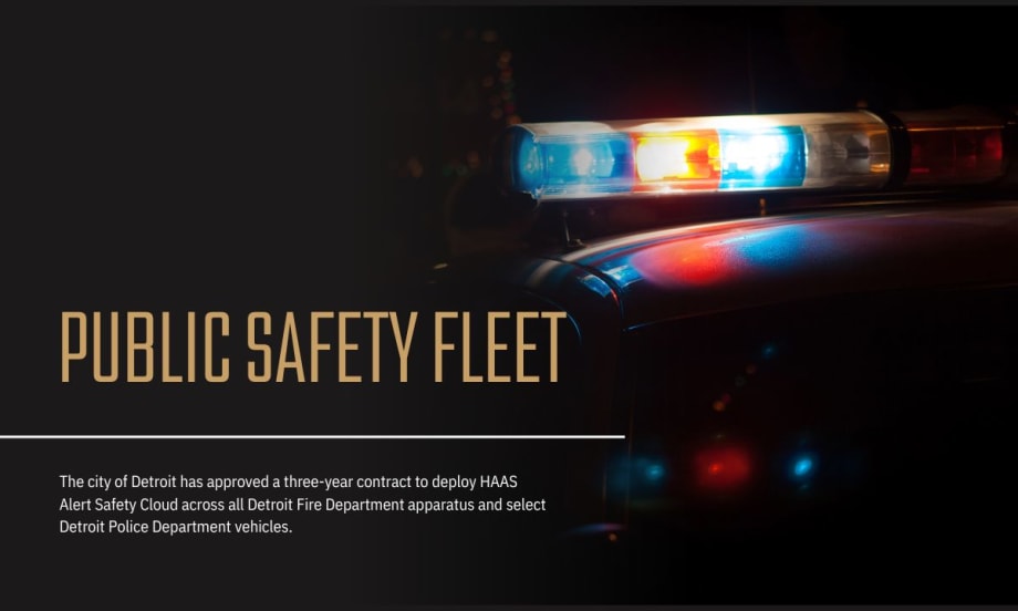 Detroit official speaks at podium with city seal, alongside police and fire leaders, with Detroit Fire vehicles in the background during Safety Cloud announcement.