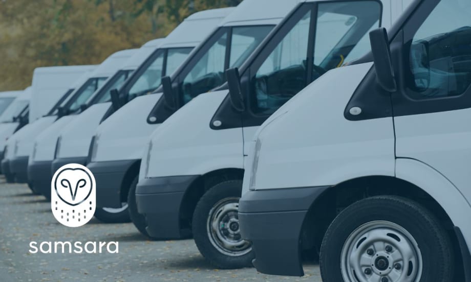 A line of parked cargo vans and the Samsara logo.