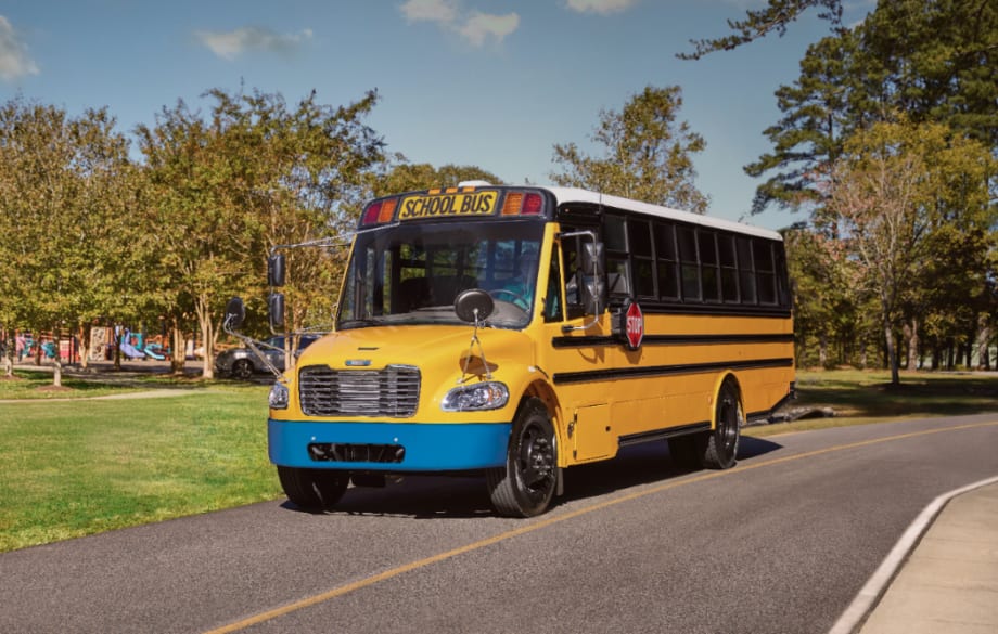 an electric school bus sits on the road