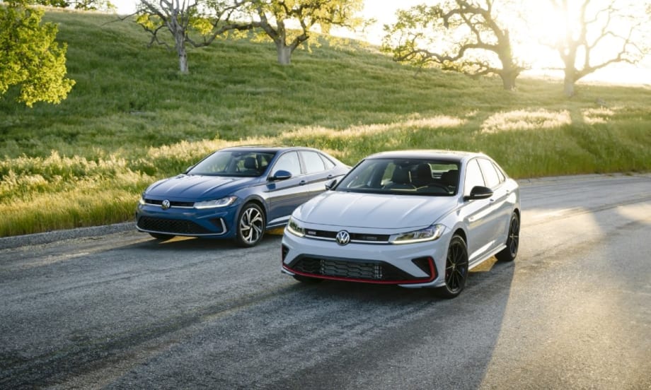 A powder blue 2025 Volkswagen Jetta and a white 2025 Jetta GLI parked on a road.